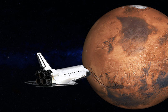 Flying space shuttle close to the Mars planet of Solar system. Mars colonization mission. Science fiction. Elements of the image are furnished by NASA