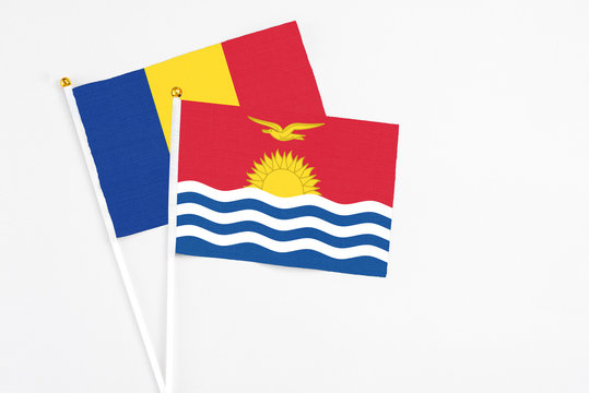 Kiribati and Romania stick flags on white background. High quality fabric, miniature national flag. Peaceful global concept.White floor for copy space.