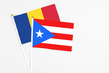 Puerto Rico and Romania stick flags on white background. High quality fabric, miniature national flag. Peaceful global concept.White floor for copy space.