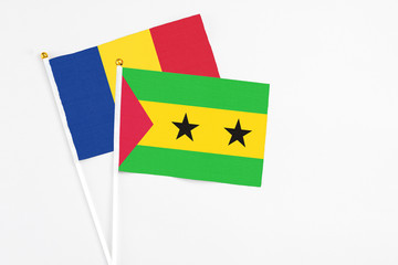 Sao Tome And Principe and Romania stick flags on white background. High quality fabric, miniature national flag. Peaceful global concept.White floor for copy space.