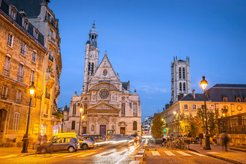 Illuminated streets of Paris during the blue hour in the evening, with Saint-Etienne-du-Mont church, Paris, France