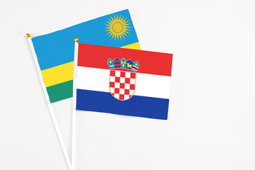 Croatia and Rwanda stick flags on white background. High quality fabric, miniature national flag....