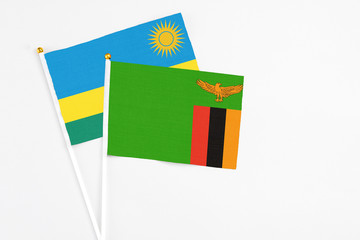 Zambia and Rwanda stick flags on white background. High quality fabric, miniature national flag. Peaceful global concept.White floor for copy space.