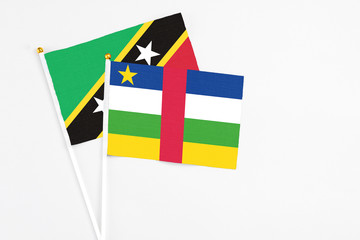 Central African Republic and Saint Kitts And Nevis stick flags on white background. High quality fabric, miniature national flag. Peaceful global concept.White floor for copy space.
