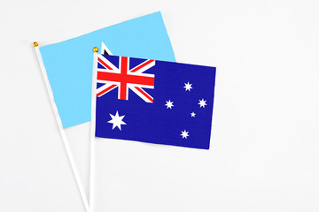 Australia and Saint Lucia stick flags on white background. High quality fabric, miniature national flag. Peaceful global concept.White floor for copy space.