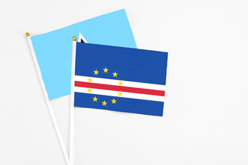 Cape Verde and Saint Lucia stick flags on white background. High quality fabric, miniature national flag. Peaceful global concept.White floor for copy space.