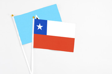 Chile and Saint Lucia stick flags on white background. High quality fabric, miniature national flag. Peaceful global concept.White floor for copy space.