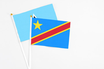 Congo and Saint Lucia stick flags on white background. High quality fabric, miniature national flag. Peaceful global concept.White floor for copy space.