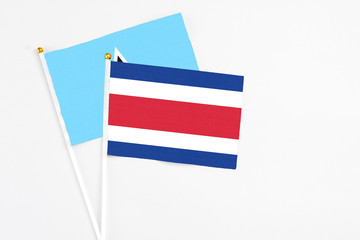 Costa Rica and Saint Lucia stick flags on white background. High quality fabric, miniature national flag. Peaceful global concept.White floor for copy space.
