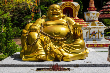 Lucky seated golden Buddha in Wat Wanararm or What Kho Wanararm Temple in Langkawi island, also known as Pulau Langkawi, State of Kedah, Malaysia.