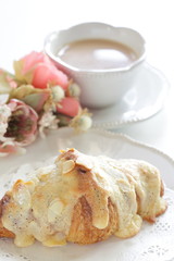Sugar and almond croissant on dish for breakfast