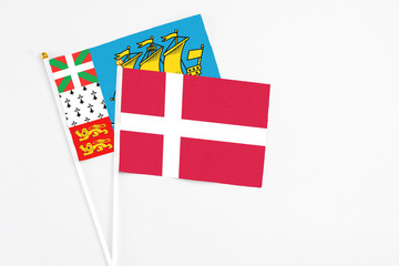 Denmark and Saint Pierre And Miquelon stick flags on white background. High quality fabric, miniature national flag. Peaceful global concept.White floor for copy space.