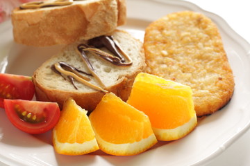 Freshness cut fruit, orange and toast with hashed brown for breakfast