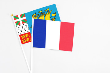 France and Saint Pierre And Miquelon stick flags on white background. High quality fabric, miniature national flag. Peaceful global concept.White floor for copy space.