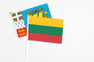 Lithuania and Saint Pierre And Miquelon stick flags on white background. High quality fabric, miniature national flag. Peaceful global concept.White floor for copy space.