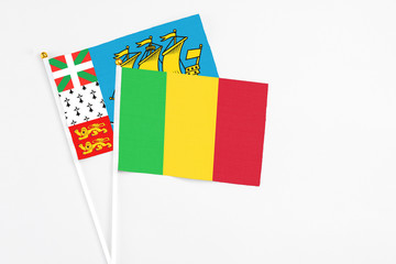Mali and Saint Pierre And Miquelon stick flags on white background. High quality fabric, miniature national flag. Peaceful global concept.White floor for copy space.