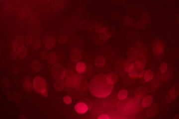 Red gold Festive Christmas Beautiful abstract Background with bokeh lights. Holiday Texture with copy space. Can be used as Wallpaper, filling for a website, defocused