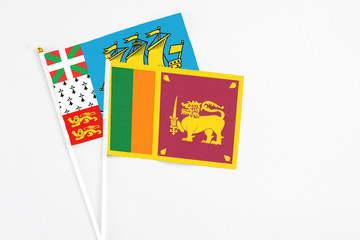 Sri Lanka and Saint Pierre And Miquelon stick flags on white background. High quality fabric, miniature national flag. Peaceful global concept.White floor for copy space.