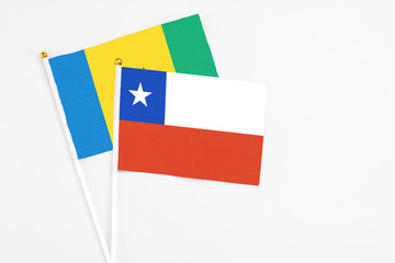 Chile and Saint Vincent And The Grenadines stick flags on white background. High quality fabric, miniature national flag. Peaceful global concept.White floor for copy space.
