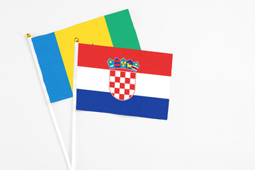 Croatia and Saint Vincent And The Grenadines stick flags on white background. High quality fabric, miniature national flag. Peaceful global concept.White floor for copy space.