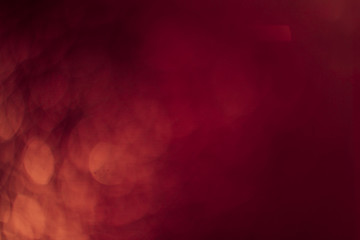 Red gold Festive Christmas Beautiful abstract Background with bokeh lights. Holiday Texture with copy space. Can be used as Wallpaper, filling for a website, defocused