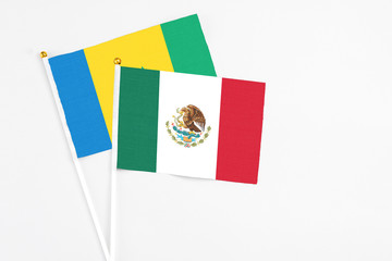 Mexico and Saint Vincent And The Grenadines stick flags on white background. High quality fabric,...