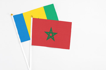 Morocco and Saint Vincent And The Grenadines stick flags on white background. High quality fabric,...