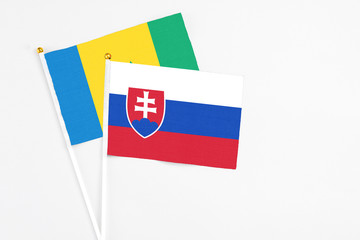 Slovakia and Saint Vincent And The Grenadines stick flags on white background. High quality fabric,...