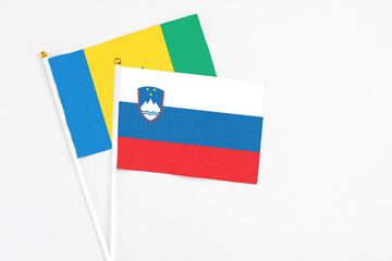 Slovenia and Saint Vincent And The Grenadines stick flags on white background. High quality fabric,...