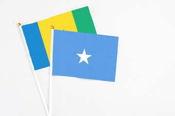 Somalia and Saint Vincent And The Grenadines stick flags on white background. High quality fabric, miniature national flag. Peaceful global concept.White floor for copy space.