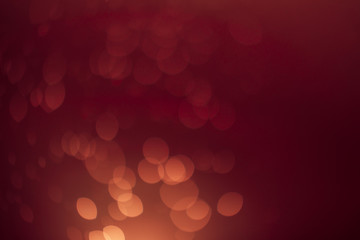 Red gold Festive Christmas Beautiful abstract Background with bokeh lights. Holiday Texture with copy space. Can be used as Wallpaper, filling for a website, defocused