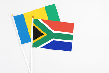 South Africa and Saint Vincent And The Grenadines stick flags on white background. High quality fabric, miniature national flag. Peaceful global concept.White floor for copy space.