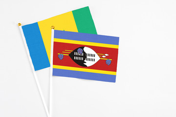 Swaziland and Saint Vincent And The Grenadines stick flags on white background. High quality...