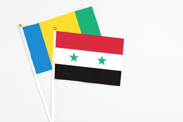 Syria and Saint Vincent And The Grenadines stick flags on white background. High quality fabric, miniature national flag. Peaceful global concept.White floor for copy space.