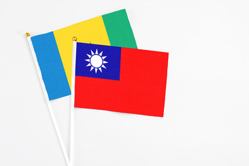 Taiwan and Saint Vincent And The Grenadines stick flags on white background. High quality fabric, miniature national flag. Peaceful global concept.White floor for copy space.