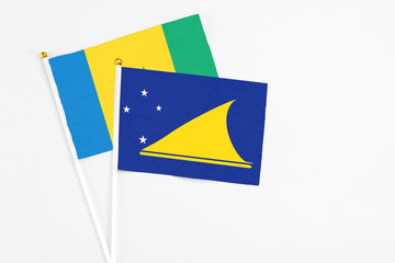 Tokelau and Saint Vincent And The Grenadines stick flags on white background. High quality fabric,...