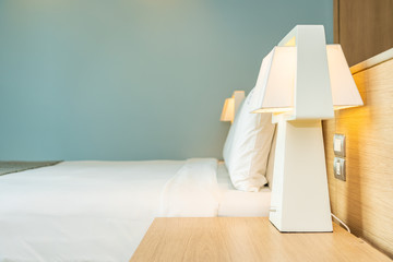 Pillow and blanket on bed with light lamp decoration interior