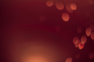 Red gold Festive Christmas Beautiful abstract Background with bokeh lights. Holiday Texture with copy space. Can be used as Wallpaper, filling for a website, defocused