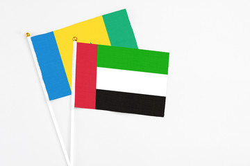 United Arab Emirates and Saint Vincent And The Grenadines stick flags on white background. High quality fabric, miniature national flag. Peaceful global concept.White floor for copy space.