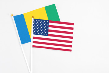 United States and Saint Vincent And The Grenadines stick flags on white background. High quality...