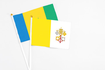 Vatican City and Saint Vincent And The Grenadines stick flags on white background. High quality...