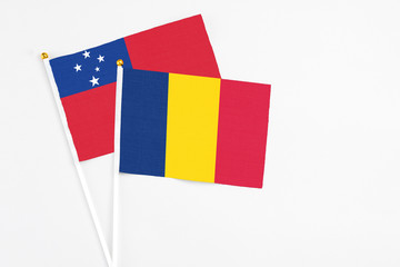 Chad and Samoa stick flags on white background. High quality fabric, miniature national flag. Peaceful global concept.White floor for copy space.