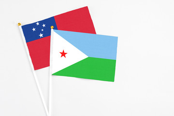 Djibouti and Samoa stick flags on white background. High quality fabric, miniature national flag. Peaceful global concept.White floor for copy space.