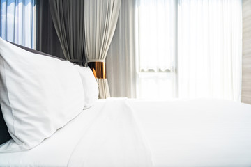 Fototapeta na wymiar White pillow on bed decoration interior