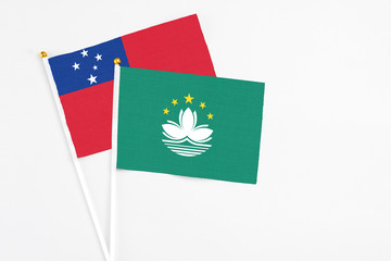 Macao and Samoa stick flags on white background. High quality fabric, miniature national flag. Peaceful global concept.White floor for copy space.