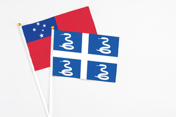 Martinique and Samoa stick flags on white background. High quality fabric, miniature national flag. Peaceful global concept.White floor for copy space.
