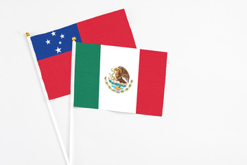 Mexico and Samoa stick flags on white background. High quality fabric, miniature national flag. Peaceful global concept.White floor for copy space.