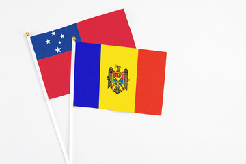 Moldova and Samoa stick flags on white background. High quality fabric, miniature national flag. Peaceful global concept.White floor for copy space.