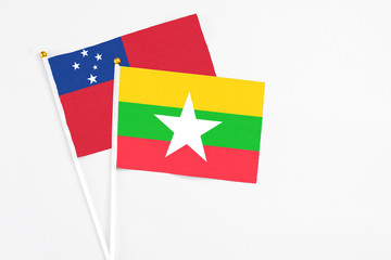 Myanmar and Samoa stick flags on white background. High quality fabric, miniature national flag. Peaceful global concept.White floor for copy space.