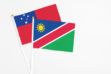 Namibia and Samoa stick flags on white background. High quality fabric, miniature national flag. Peaceful global concept.White floor for copy space.